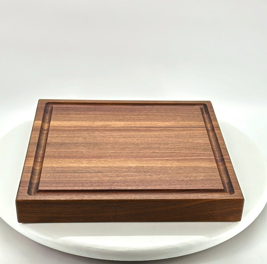 Walnut cutting block with juice groove.