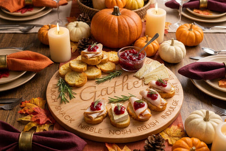 A round wooden coaster engraved with the word 'Gather' in the center and various food and drink terms around the edge, shown on a holiday table setting as an example of use.