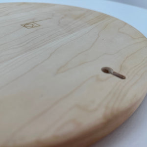 Close-up of a round the back of serving tray with hanging hole.