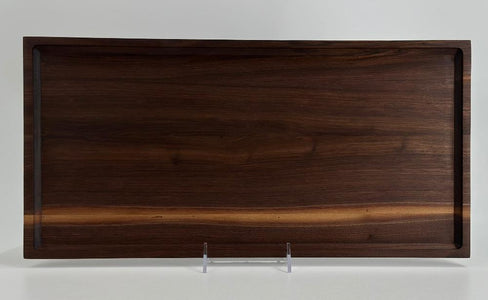 long walnut tray propped up on side 