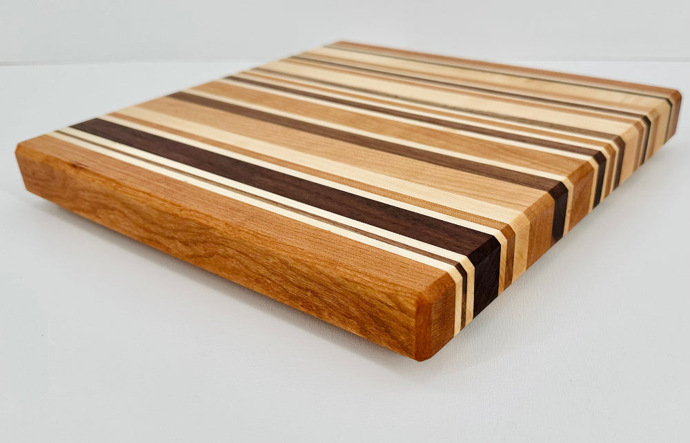 Wooden cutting board with striped pattern on a light gray background