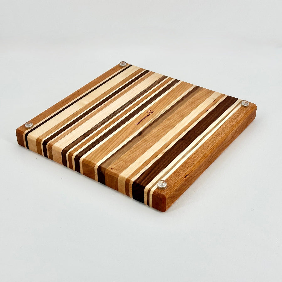 Wooden cutting board with striped pattern on a light gray background