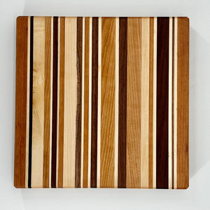 Wooden cutting board with striped pattern on a white background