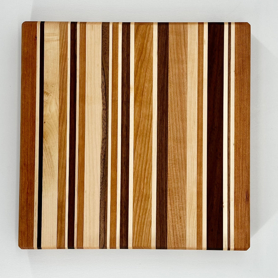 Wooden cutting board with striped pattern on a white background