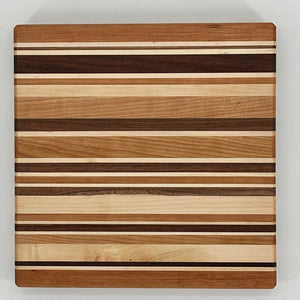 Wooden cutting board with striped pattern on a white background