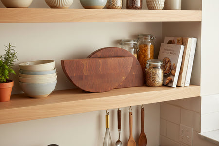 two wood cutting blocks sitting on shelf with other kitchen items.