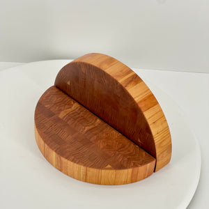 Wooden cutting board with a unique design on a white surface